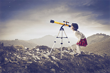 Girl looking through telescope.